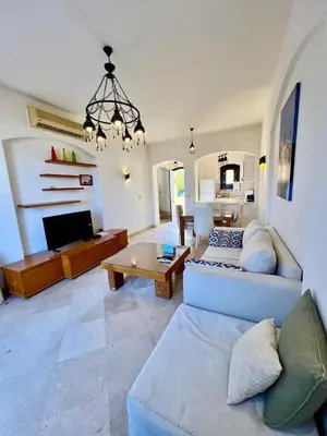 a living room with a couch and a table at wast golf y 39-0-2 in Hurghada