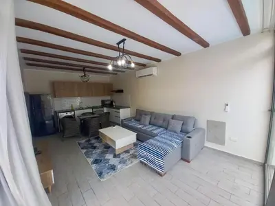 a living room with a couch and a kitchen at Bali D-28 in Hurghada