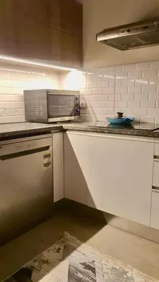 a kitchen with white cabinets and a counter top at Bali D-28 in Hurghada