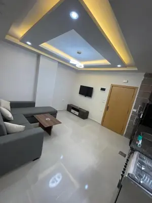 a living room with a couch and a table at Elamer building in Hurghada