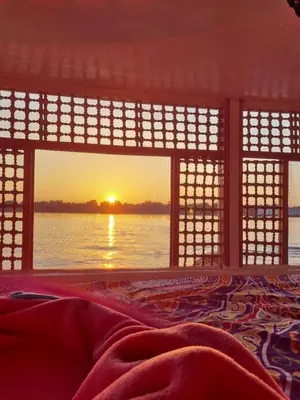 a view of a sunset from a room with a window at The Adventures of Aga Khan in Aswan