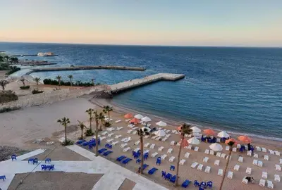 an aerial view of a beach with umbrellas and chairs at Luxurious and Cozy Seafront Studio Near Gouna in Hurghada