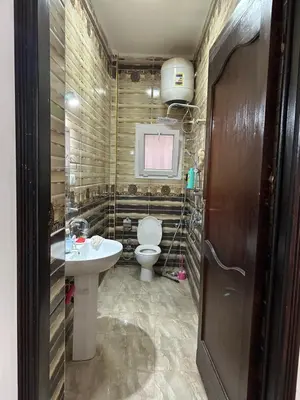 a bathroom with a toilet and a sink at Tulip residence villa 1 in Hurghada