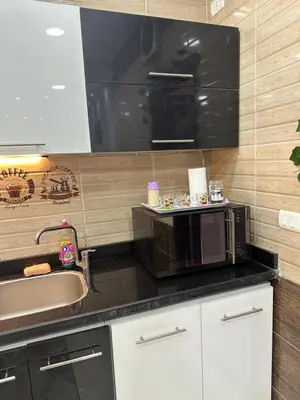 a kitchen with a sink and a microwave at Tulip residence villa 1 in Hurghada