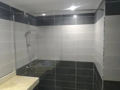 a bathroom with a shower with a toilet in it at Cozy Studio in modern resort in Hurghada
