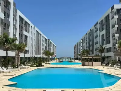 an empty swimming pool in front of apartment buildings at Cozy Studio in modern resort in Hurghada