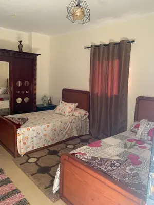 a bedroom with two beds and a mirror at for peivate and calm near gouna in Hurghada