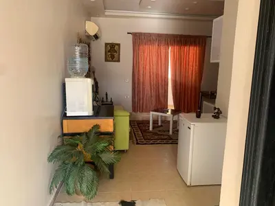 a living room with a refrigerator and a plant at for peivate and calm near gouna in Hurghada