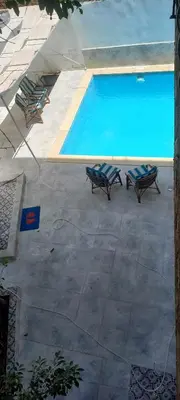 an overhead view of a swimming pool with two lounge chairs at Villa Rose - Luxor in Luxor