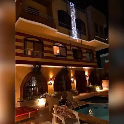 a large building with a swimming pool in front of it at Golden key in Hurghada