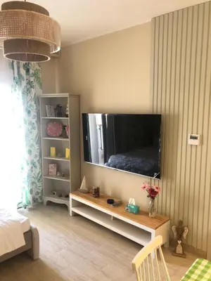 a living room with a large flat screen tv at Super luxury hotel apartment in Hurghada