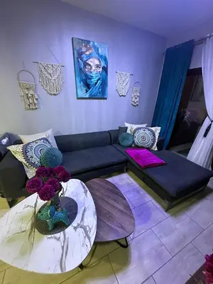 a living room with a couch and a table at Super luxury hotel apartment in Hurghada