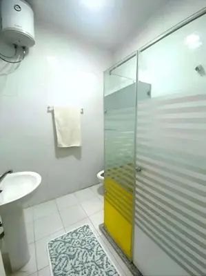 a bathroom with a glass shower and a sink at Hadaba Studio in Hurghada