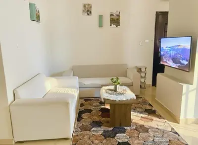 a living room with a couch and a tv at Hadaba Studio in Hurghada