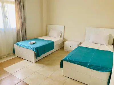a bedroom with two beds with blue and white at Magawish villa in the heart of the city in Hurghada