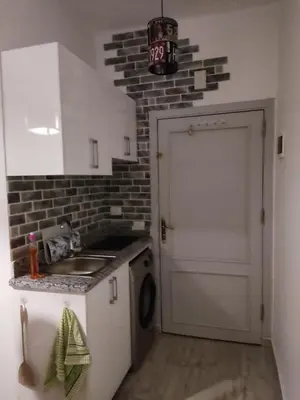 a small kitchen with a sink and a stove at Aqua Palms Resort Hurghada in Hurghada