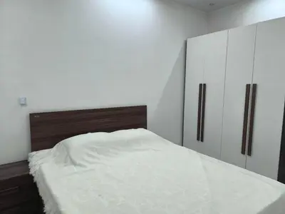 a bedroom with a white bed and white cabinets at New 2bedroom apartment 7 min drive from Sheraton in Hurghada