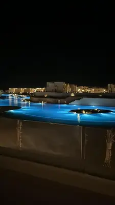 a group of blue lights in the water at night at Mackdi hights in Hurghada