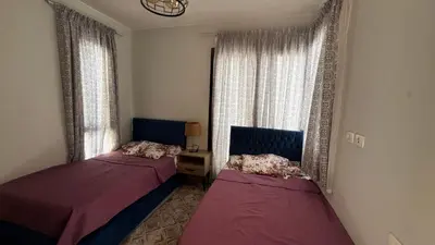 a room with two beds and two windows at Mackdi hights in Hurghada