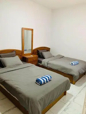 a bedroom with two beds and a mirror at One Bedroom At Turtle Beach Compound With Private Beach in Hurghada