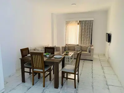 a living room with a table and chairs and a couch at One Bedroom At Turtle Beach Compound With Private Beach in Hurghada