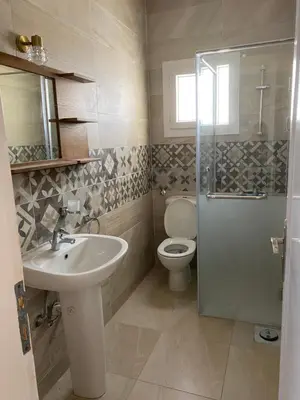 a bathroom with a toilet and a sink and a shower at Andreas Residence in Hurghada