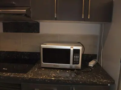 a microwave sitting on a counter in a kitchen at Victoria Aldau Heights Hurghada rent one bedroom Apartment in Hurghada