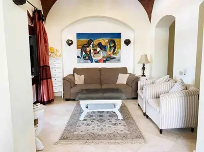 a living room with a couch and a coffee table at Private Villa with heated pool and lagoon in Hurghada