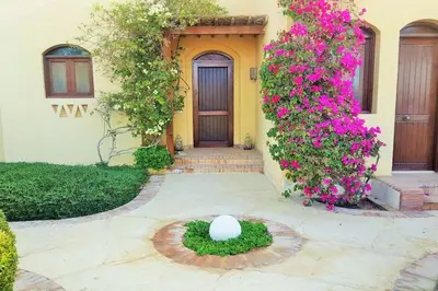 a house with a statue in front of a door at Private Villa with heated pool and lagoon in Hurghada
