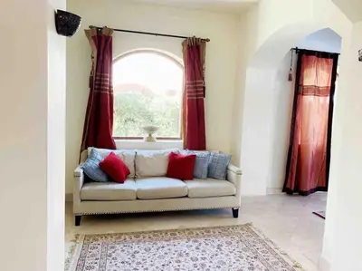 a living room with a couch and a window at Private Villa with heated pool and lagoon in Hurghada