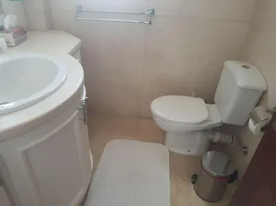 a bathroom with a white toilet and a sink at Villa, with heated Pool and Lagoon in Hurghada