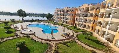 an aerial view of a resort with a swimming pool at Nile Front Luxor Apt Sleeps 6 with Pool in Luxor