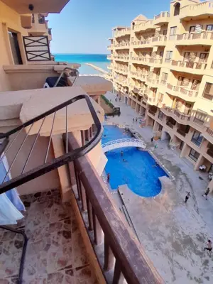 a view from the balcony of a hotel with a swimming pool at Turtles Beach resort hourghada Studio view sea view pool private beach jacuzzi pools air-conditioned restaurant on the beach jacuzzi security and a large sunny balcony in Hurghada