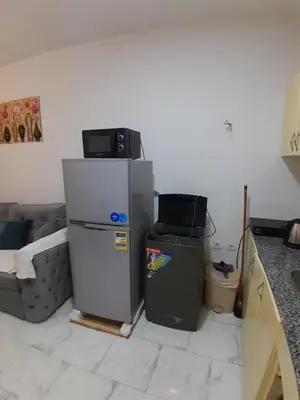 a kitchen with a refrigerator and a couch at Turtles Beach resort hourghada Studio view sea view pool private beach jacuzzi pools air-conditioned restaurant on the beach jacuzzi security and a large sunny balcony in Hurghada