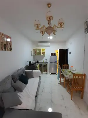 a living room with a couch and a table at Turtles Beach resort hourghada Studio view sea view pool private beach jacuzzi pools air-conditioned restaurant on the beach jacuzzi security and a large sunny balcony in Hurghada