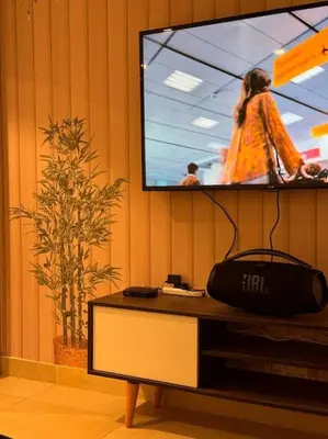 a flat screen tv on a wall with a woman on it at Amazing Mangroovy 1 BD in gouna in Hurghada