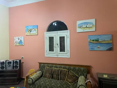 a living room with a couch and a window at MelissaKato in Naj‘ al Maḩaţţah
