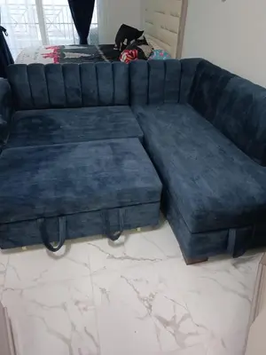 a blue couch sitting in a living room at Juliana beach in Hurghada