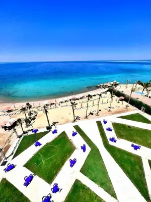 a view of a beach with umbrellas and the ocean at Juliana beach in Hurghada