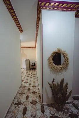 a hallway with a room with a wall with a mirror at Wanees Hostel in Aswan
