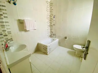 a white bathroom with a sink and a toilet at Hurghada-Magawish Villa 5 in Hurghada