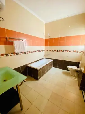 a bathroom with a tub and a toilet and a sink at Hurghada-Magawish Villa 5 in Hurghada
