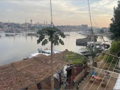 a view of a river with boats in a harbor at شقق للإيجار بأسوان in Aswan