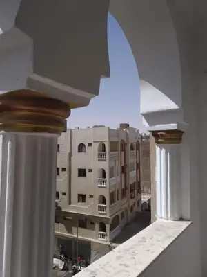 a view of a large building from a window at Sheraton Plaza house near the beaches and near New Marina studio 428 in Hurghada
