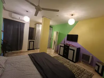 a bedroom with a bed and a flat screen tv at Apartment Duplex Flat - Private Garden - 2 Floors in Hurghada