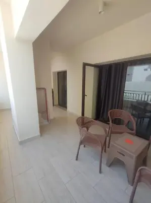 a room with chairs and a table and a window at Diamond Lily Aldau heights Hurghada rent one bedroom apartment in Hurghada