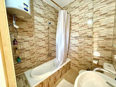 a bathroom with a tub and a sink and a shower at Magic Quest Retreat 10 min von Aswan in Nag` el-Fuqâhi