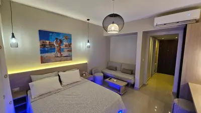 a small bedroom with a bed and a couch at G Cribs Stylish Studio in Hurghada