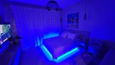 a bedroom with a bed with a blue light at G Cribs Stylish Studio in Hurghada
