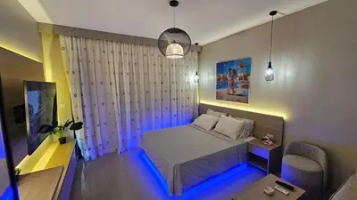 a bedroom with a bed with a blue led lighting at G Cribs Stylish Studio in Hurghada